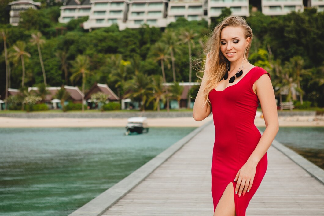 Front Page -UK Skirt Sales 2023 young beautiful attractive woman standing alone pier luxury resort hotel summer vacation red long dress blond hair sexy apparel tropical beach seductive sensual smiling 285396 6302